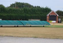 Cricket pitch covers at a sports field in Audley, England, on a clear day.