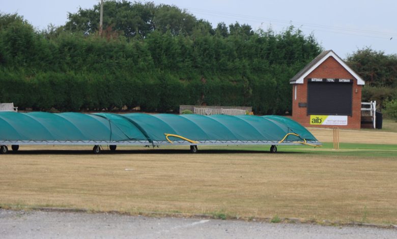 Cricket pitch covers at a sports field in Audley, England, on a clear day.