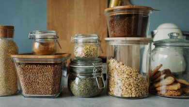 Stylish pantry setup with a variety of foods in glass storage jars, showcasing dry goods and cookies.