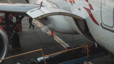 Close-up view of luggage being loaded onto an airplane at the airport.