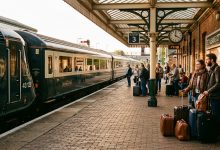Passengers waiting with luggage at a railway platform